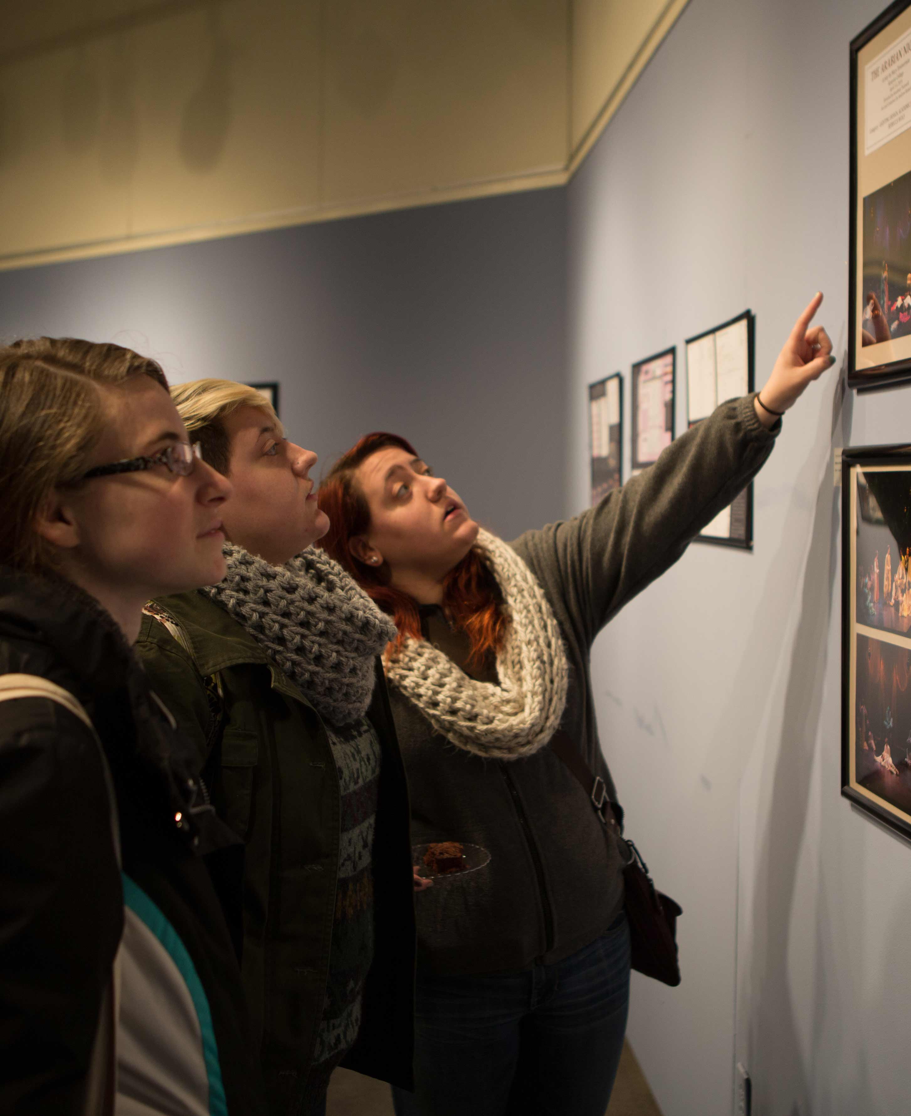 Juniors Veronica Hrovat, Jennifer Giangola and Nicole Giangola, right, looks at the exhibit.