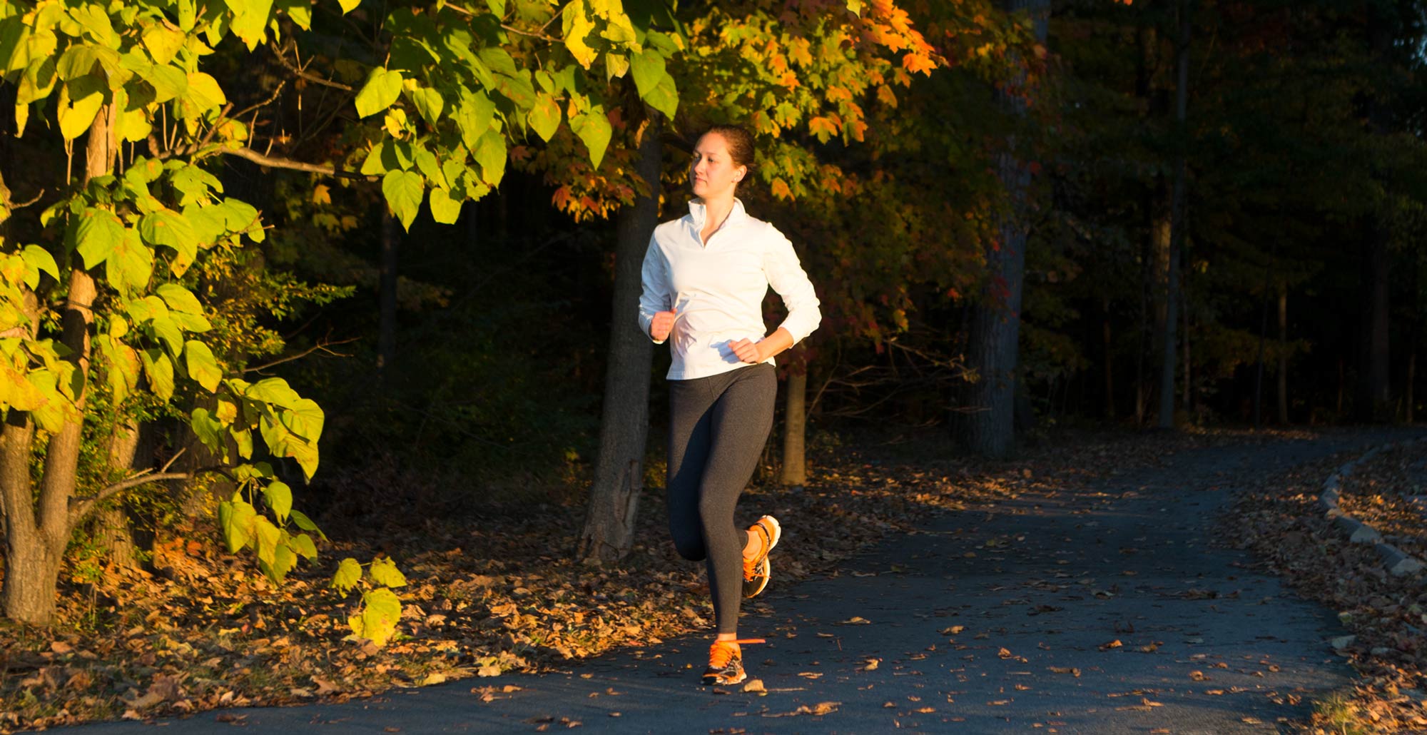 A jogger uses the Green Monster under the changing fall leaves.