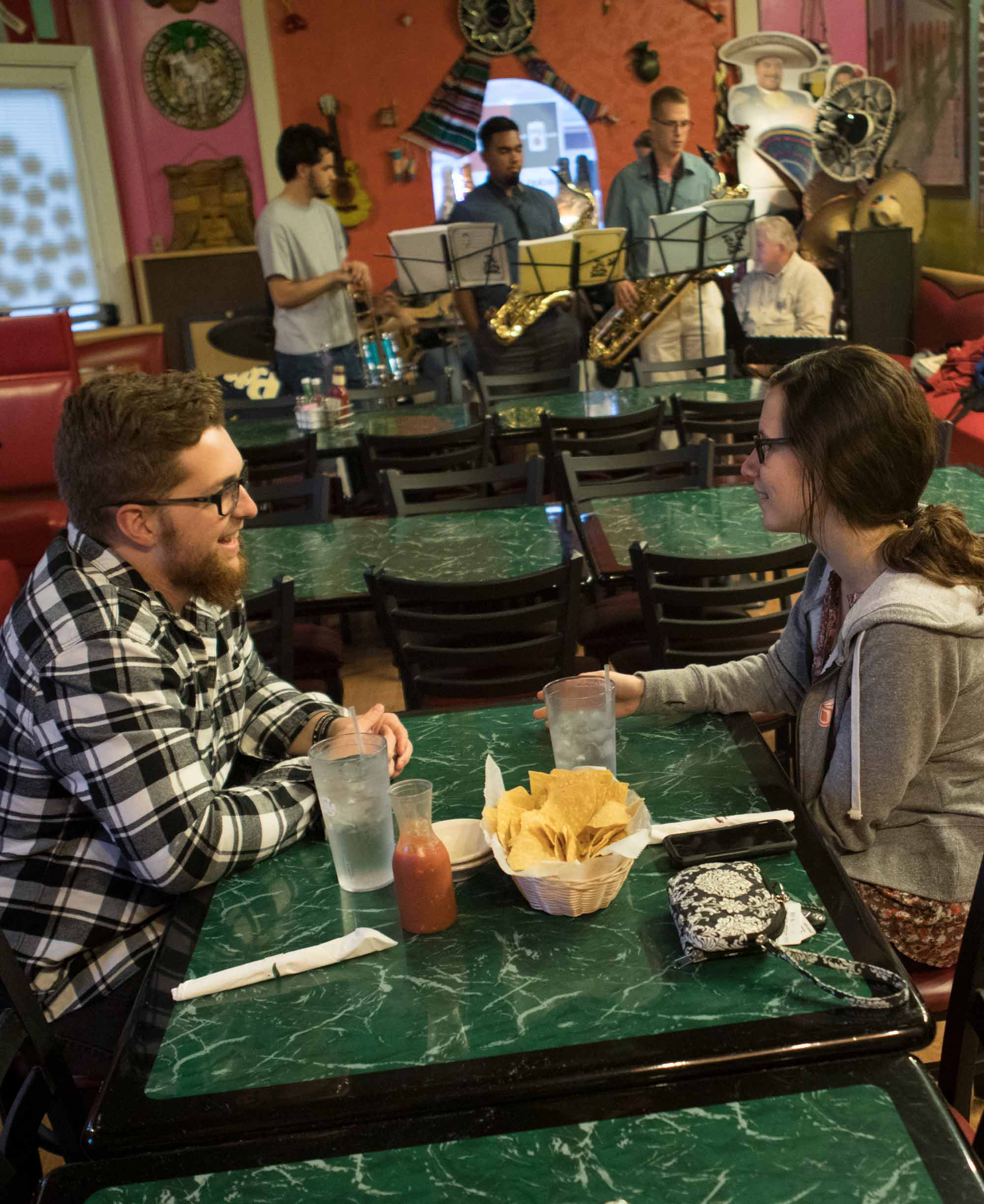 Ohio Northern University seniors Austin Douglas and Tyler Overy listen to a performance. Weekly jam sessions at El Campo Mexican Restaurant & Cantina in Ada are led by Gene Parker, adjunct professor of jazz at Ohio Northern University.