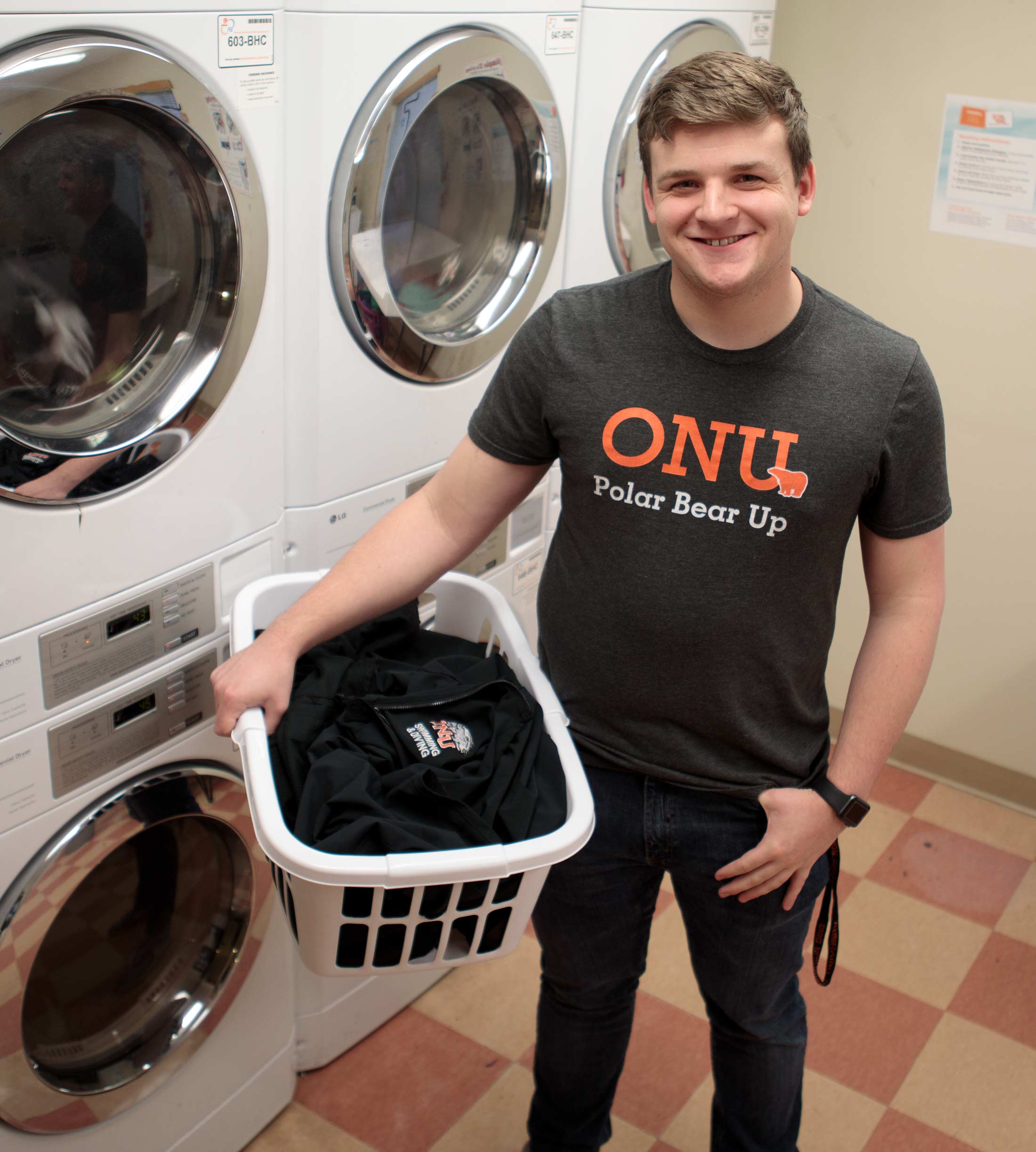 Student uses a laundry room in Stadium View apartments 