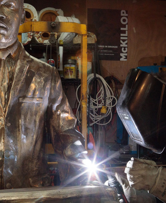 Tad McKillop welds together portions of the bare bronze before sanding and finishing. 