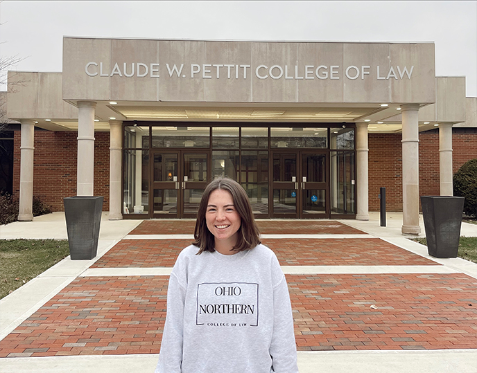 Photo of Andrea Hoffman in front of Law Building